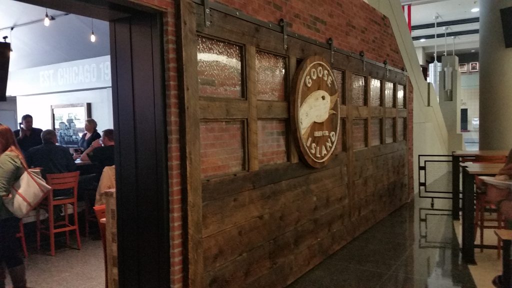 Goose Island Brewery's 402 Barn Door Hardware from Specialty Doors. A large door slab with 6 rollers & hangers on a flat track.